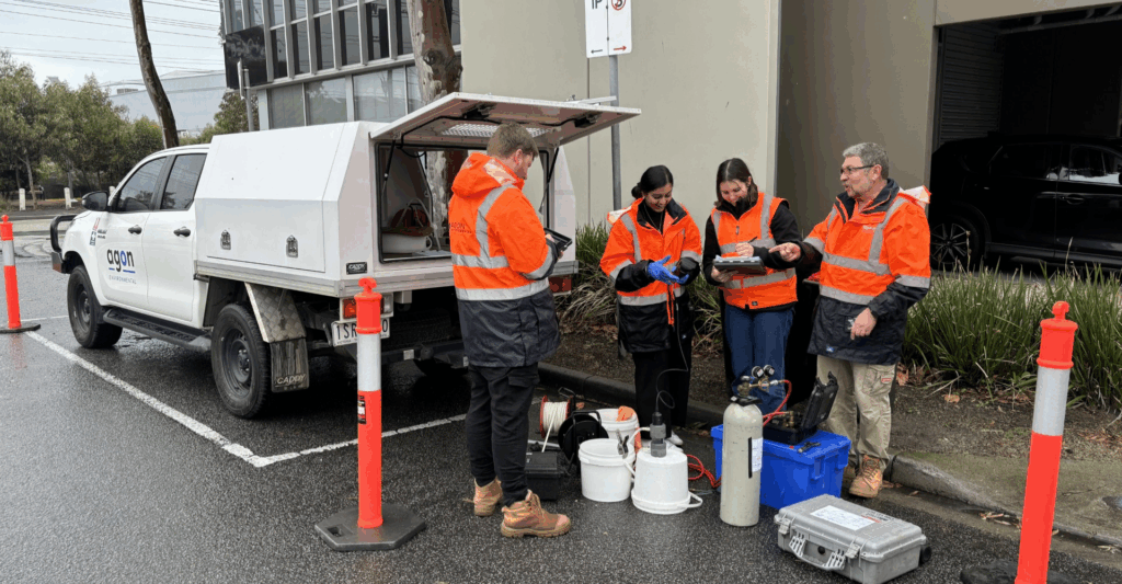 Environmental consultants in full protective gear safely handling asbestos materials during hazardous waste removal.