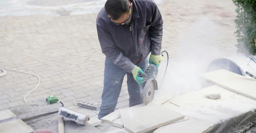 Worker conducting silica dust monitoring during construction activities to assess respirable crystalline silica exposure and workplace compliance.